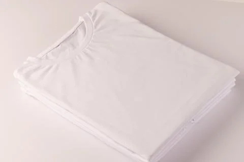 Stack of white t shirts and copy space on white background Illustrazione stock