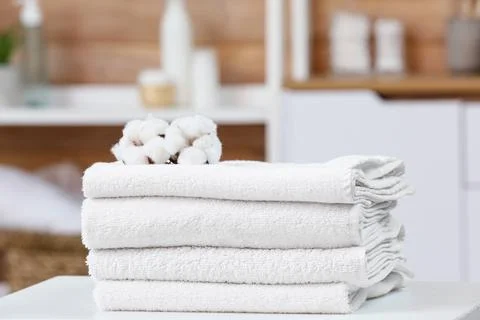 Stack of white towels with cotton flowers on top Stock Photos