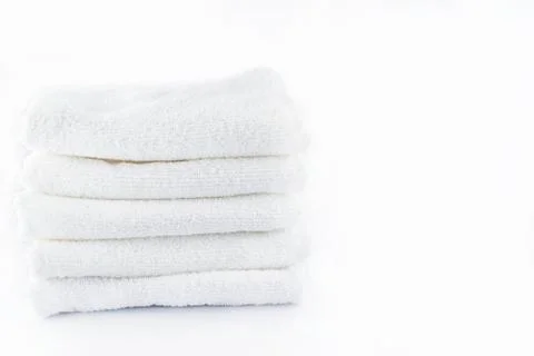 Stack of white towels on white background Stock Photos