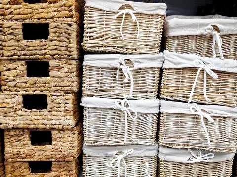 Stack of white wicker baskets boxes for towels and home stuff on shelf in b.. 스톡 사진