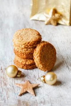Stack of whole grain cocos cookies and Christmas decoration on wood Stock Photos