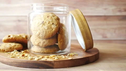 Stack of whole meal cookies in a jar on wooden background Stock Footage 156339256
