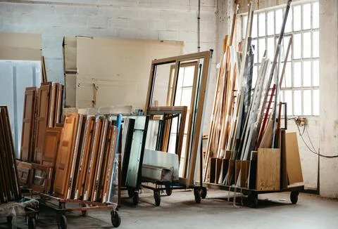 Stack of window frames and materials in metal carpentry workshop Stock Photos
