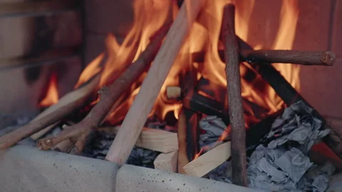 Stack of wood burning on an outdoor BBQ pit Stock Footage 345806470