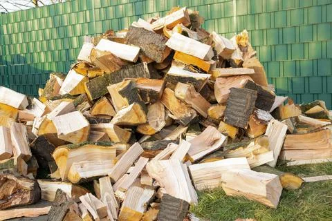 Stack of wood, chopped lie stacked on the street. Preparation for the winter Stock Photos