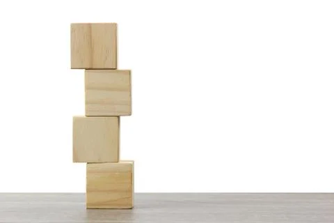 Stack of wooden block on wood table against white background. Stock Photos
