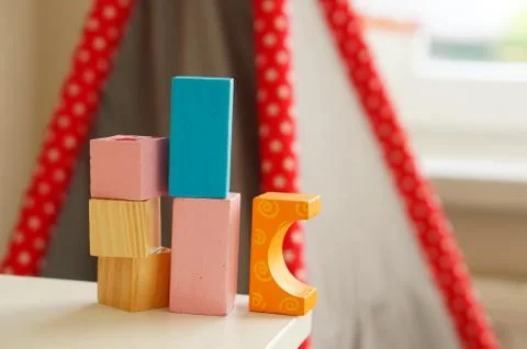 Stack of wooden blocks on the edge of a table Stock Photos