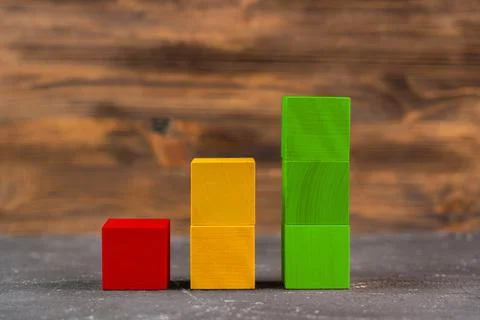 A stack of wooden blocks in the form of a ladder up, the concept of growth an Foto stock