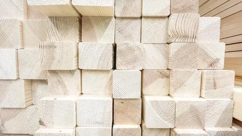A stack of wooden blocks with a red background. The blocks are all different siz Stock Photos