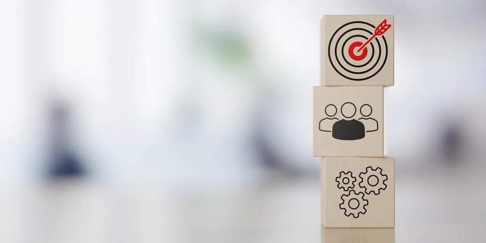 Stack of wooden blocks with team, process and goal or target icons on table.. Stock Illustration