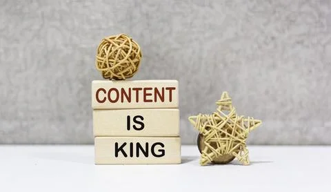 A stack of wooden blocks with writing on them CONTENT IS KING Stock Photos