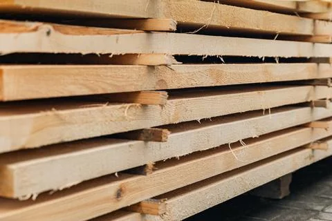 Stack of wooden boards. The boards appear rough-cut with visible knots and un Stock Photos