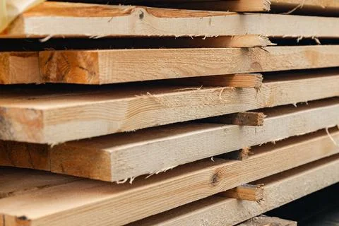 Stack of wooden boards. The boards appear rough-cut with visible knots and un Stock Photos