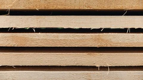 Stack of wooden boards. The boards appear rough-cut with visible knots and un Stock Photos