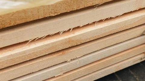 Stack of wooden boards. The boards appear rough-cut with visible knots and un Stock Photos