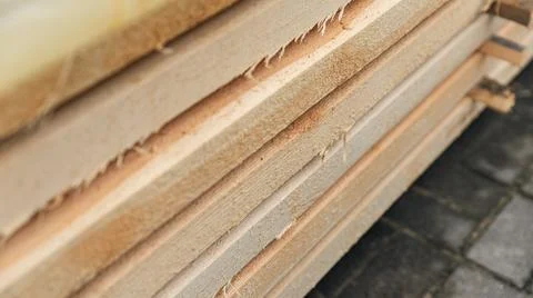 Stack of wooden boards. The boards appear rough-cut with visible knots and un Stock Photos