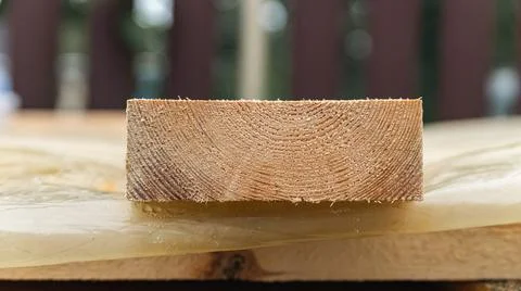Stack of wooden boards. The boards appear rough-cut with visible knots and un Stock Photos