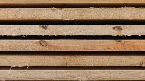 Stack of wooden boards. The boards appear rough-cut with visible knots and un Stock Photos