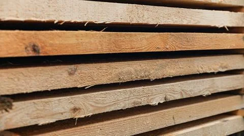 Stack of wooden boards. The boards appear rough-cut with visible knots and un Stock Photos