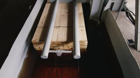 A stack of wooden boards dipped into the solution for anti-corrosion treatment Stock Footage 62404968