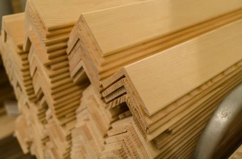 A stack of wooden corners board in store. Wooden products for construction and Stock Photos