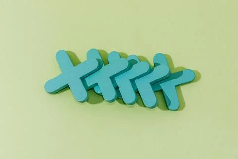 Stack of wooden crosses on green background, concept abstract pattern minimal Foto stock