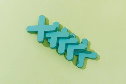 Stack of wooden crosses on green background, concept abstract pattern minimal Stock Photos