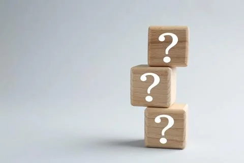 Stack of wooden cubes with question marks on light grey background, space f.. 스톡 사진