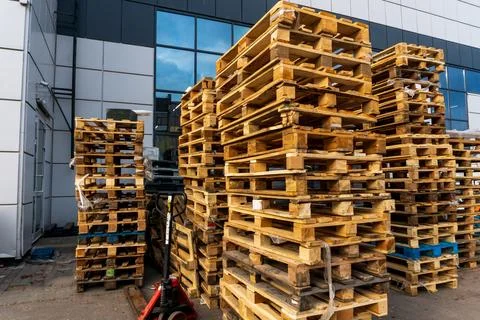 A stack of wooden pallets in an internal warehouse. An outdoor pallet storage Stock Photos