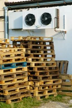 A stack of wooden pallets in an internal warehouse. An outdoor pallet storage Stock Photos