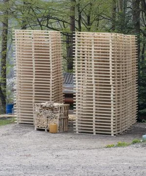 Stack of wooden pallets in the joinery workshop. Wooden pallets . Stock Photos