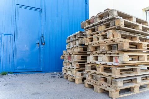 A stack of wooden shipping pallets placed outdoors Stock Photos