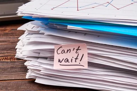 Stack of work papers with sticly note with message. Stock Photos