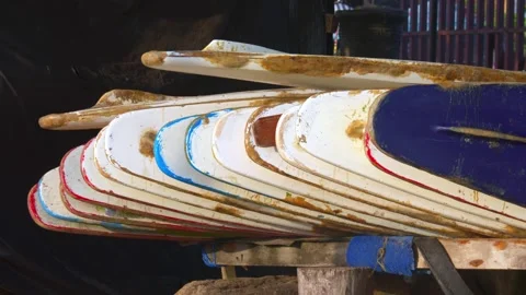 Stack of Worn Surfboards Stored on Rack at Surf School Rental Shop Stock Footage 281141578