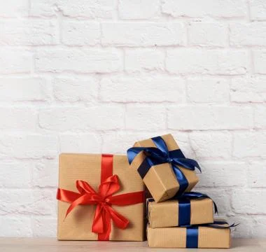 Stack of wrapped boxes in brown kraft paper and tied with silk ribbon Stock Photos