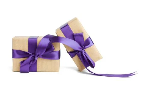 Stack of wrapped boxes in brown kraft paper and tied with silk purple ribb... Stock Photos