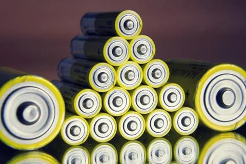 Stack of yellow AA batteries close up abstract color background 스톡 사진