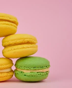 Stack of yellow and green round almond flour cakes macarons with cream on a p Stockfoto's