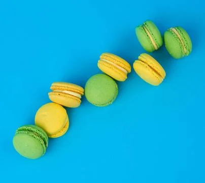 Stack of yellow and green round almond flour cakes macarons with cream sta... Stock-Fotos