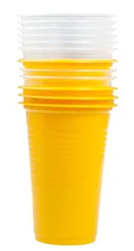 Stack of yellow and transparent plastic cups 库存照片