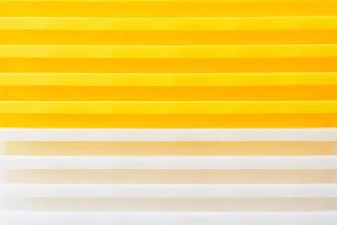 Stack of yellow and white recycled plastic containers. Duocolor background 스톡 사진