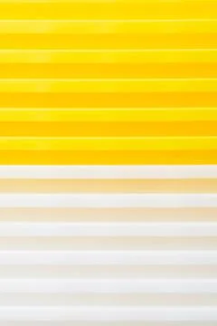 Stack of yellow and white recycled plastic containers. Duocolor background 스톡 사진
