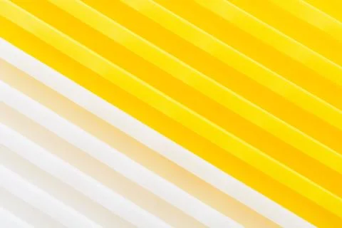 Stack of yellow and white recycled plastic containers. Duocolor background 스톡 사진