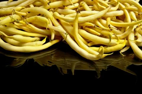 Stack of yellow beans on black background Stock Photos