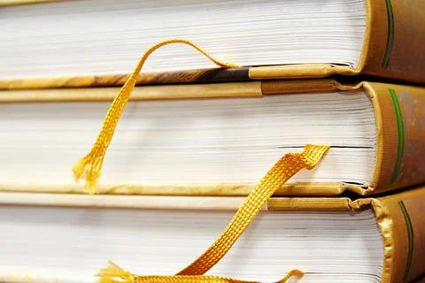 Stack of yellow books with bookmarks and hardcover Stock Photos