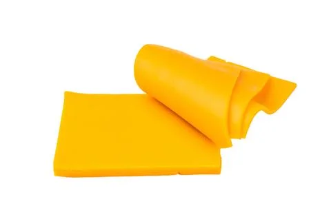 Stack of yellow cheese slices on white backdrop processed dairy ingredient .. Stock Photos