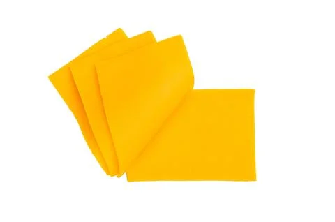 Stack of yellow cheese slices on white backdrop processed dairy ingredient .. Foto stock