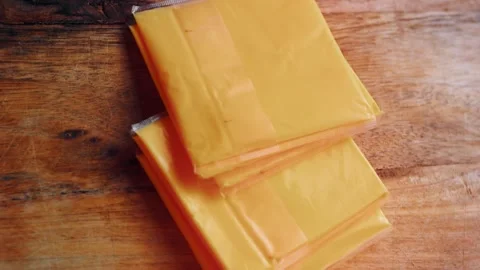 Stack of yellow cheese slices on the work surface, 4K Stock Footage 341117466