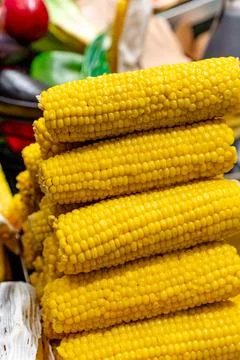 A stack of yellow corn on a table Stock Photos