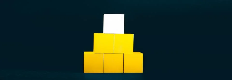 Stack of yellow cubes with blank card on black background, business concept 스톡 사진